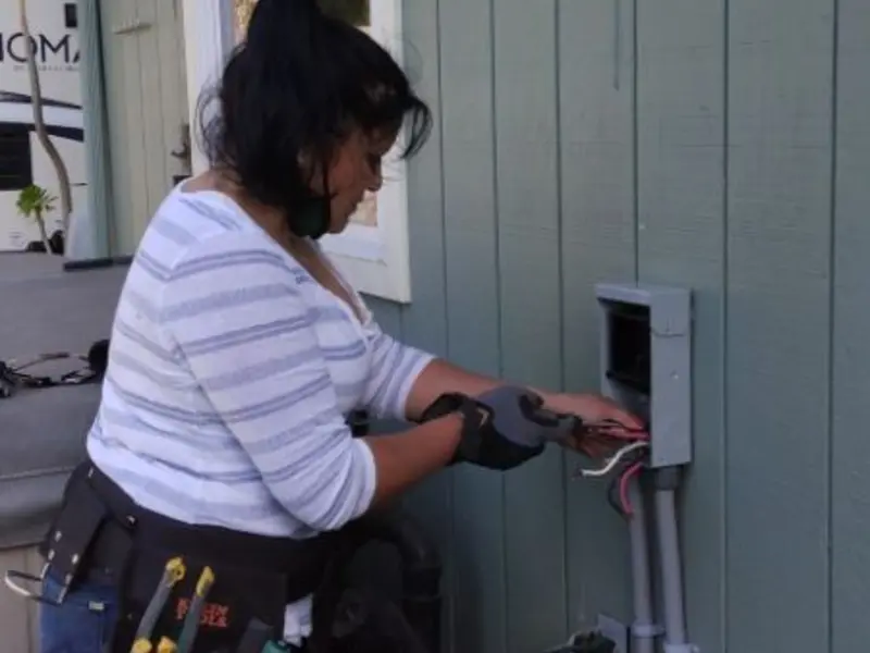 Licensed electrician wiring an exterior subpanel in Bridgton
